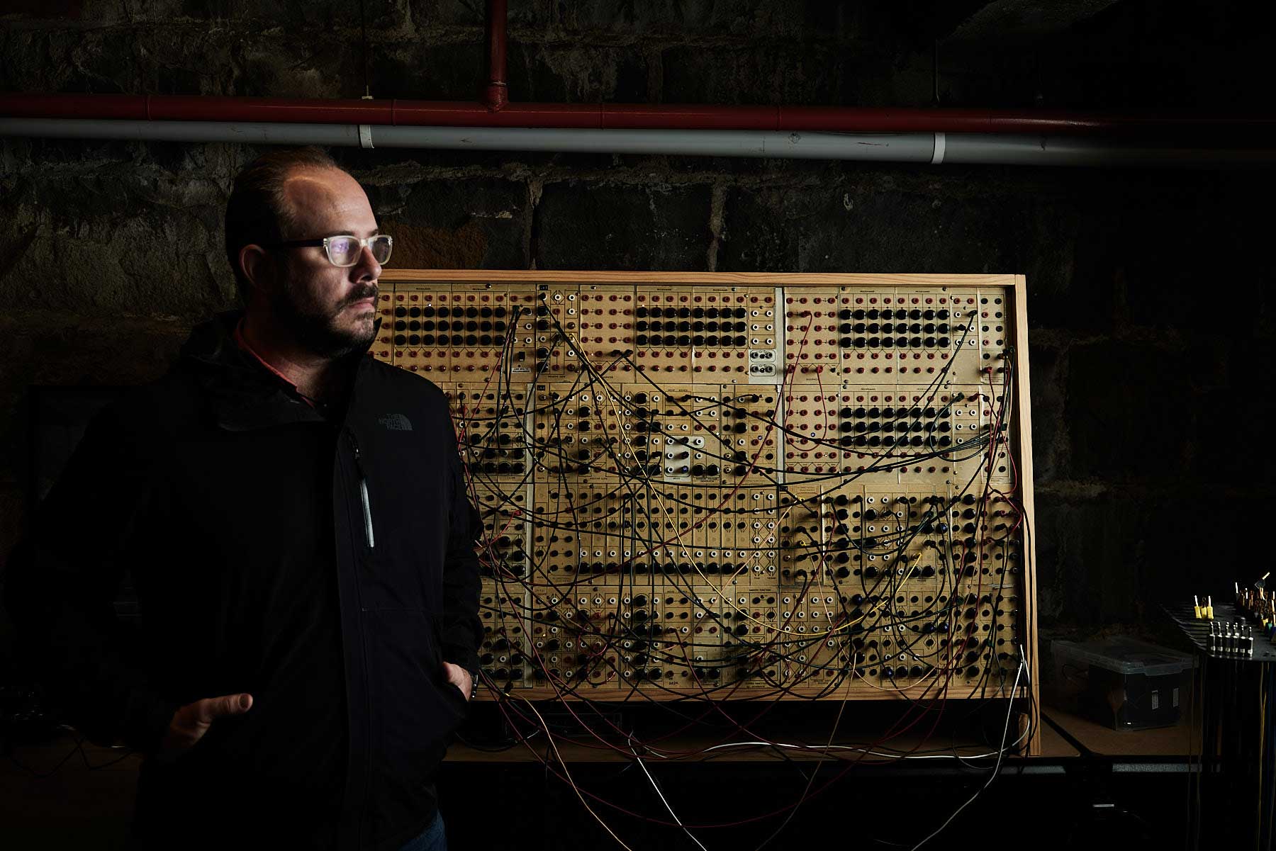 Ben Carey standing in front of the Serge 'Paperface' synthesiser.