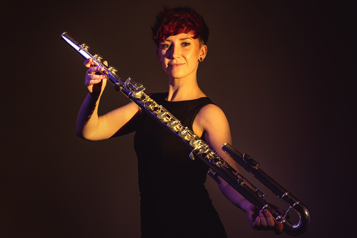 Eliza Shephard holds up a bass flute.
