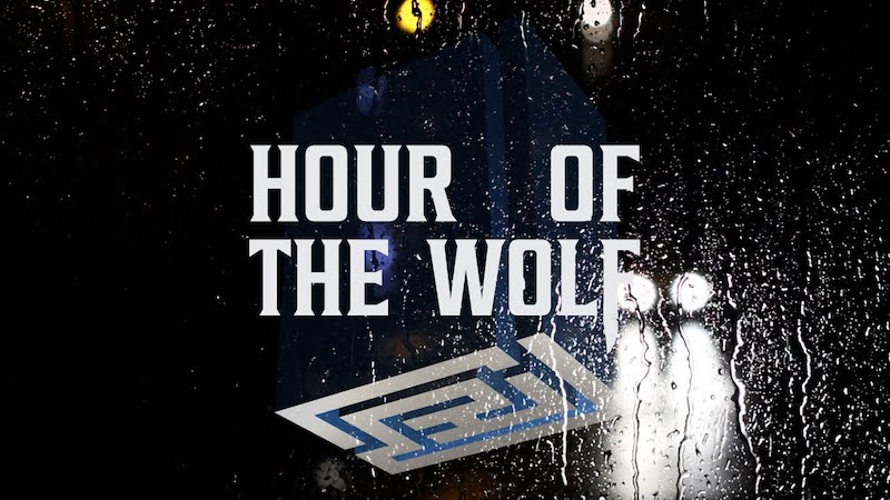 A rainy window obscures headlights, with a strange pattern superimposed on top wth the text 'Hour of the Wolf'.