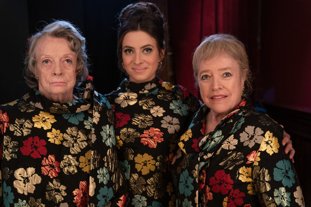 Maggie Smith, Agnes O’Casey and Kathy Bates stand next to each other in the same colourful floral dresses.
