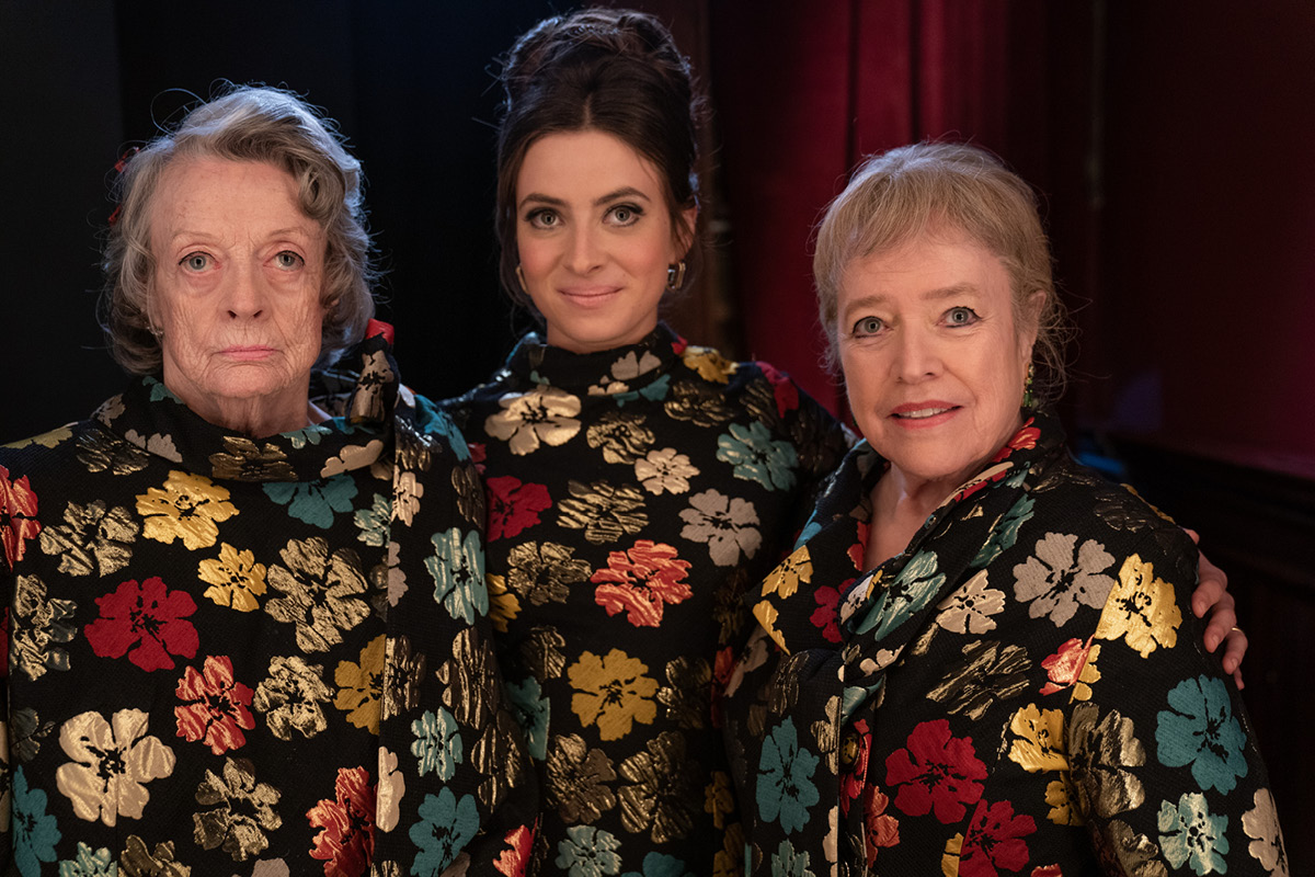 Maggie Smith, Agnes O’Casey and Kathy Bates stand next to each other in matching embroidered floral dresses.