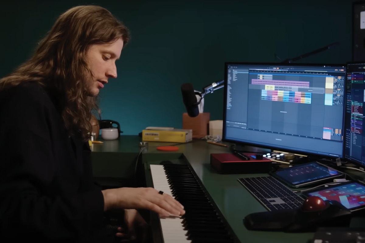 Ludwig Göransson plays a MIDI keyboard in front of computer monitors.