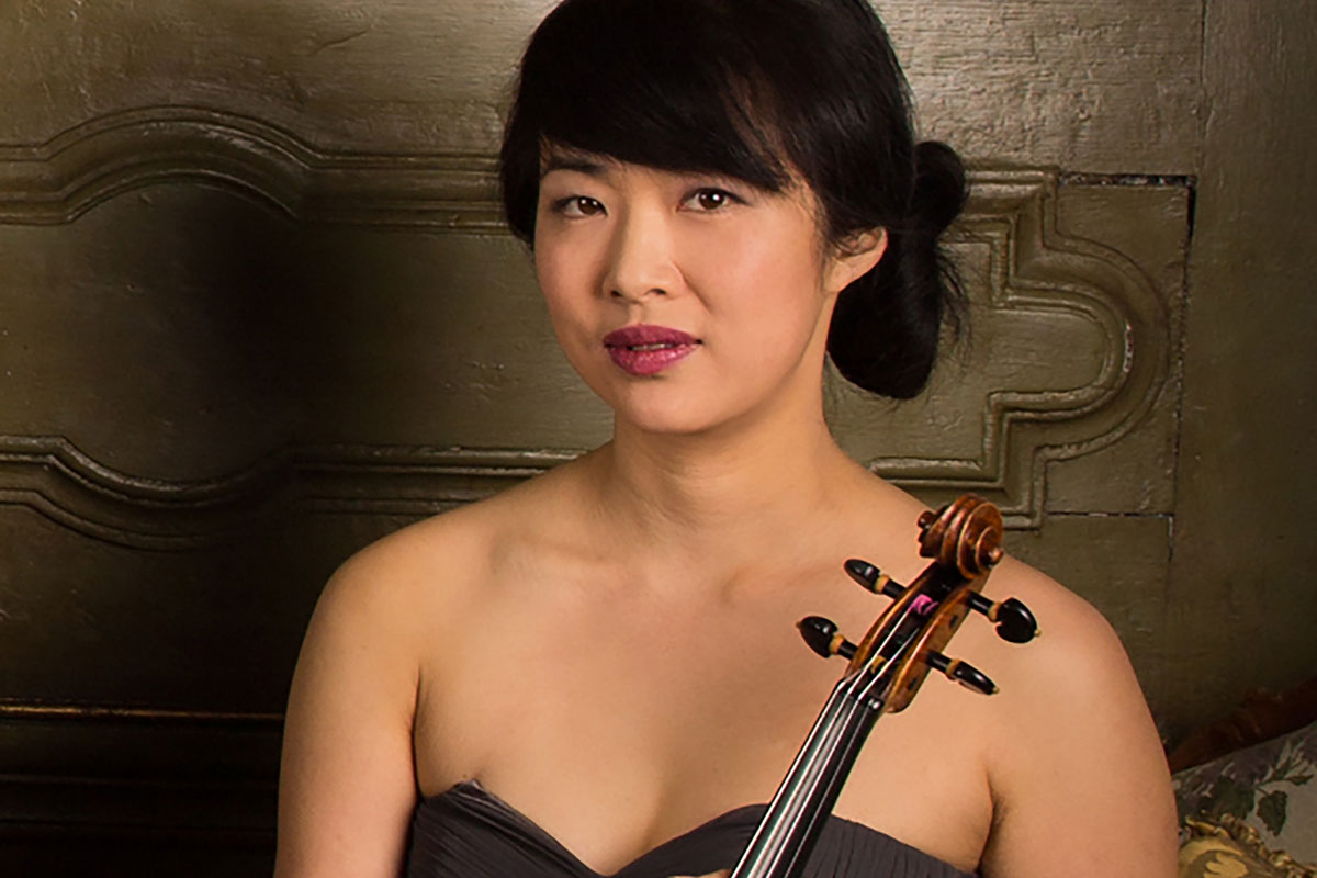Rebecca Chan holds up her violin.