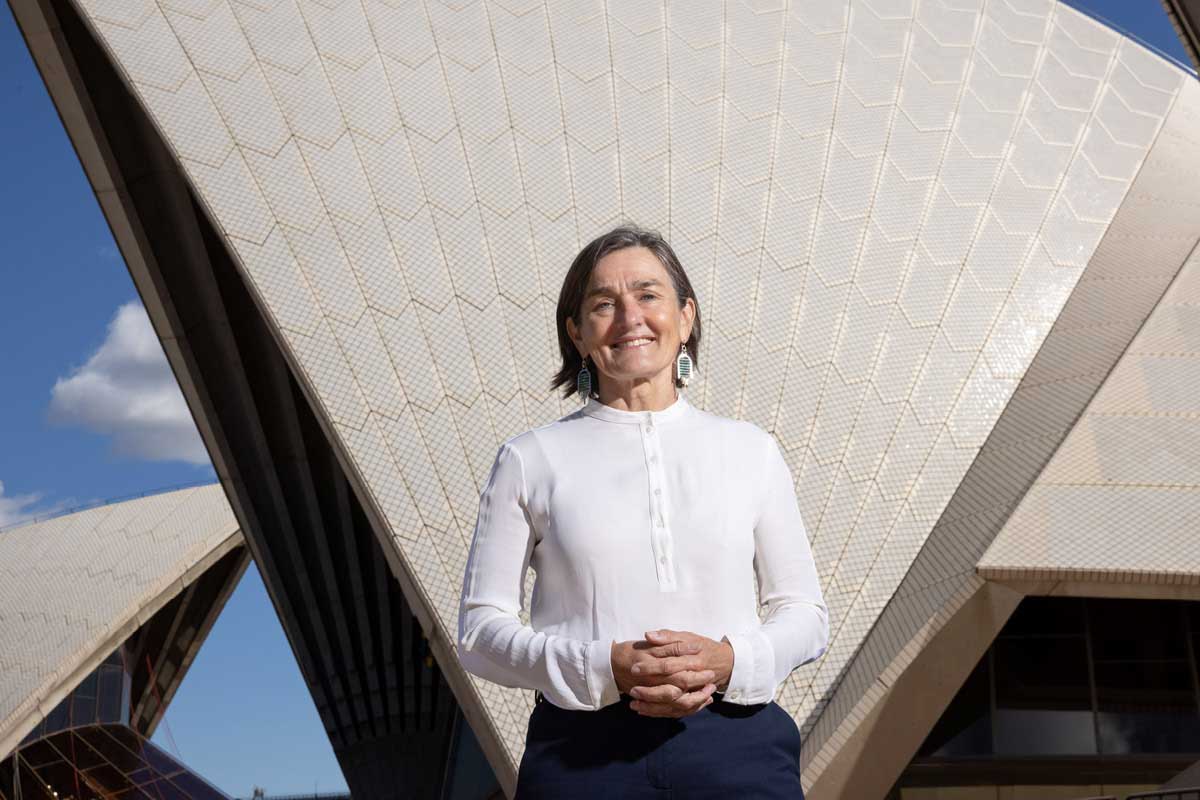 Louise Herron stands in front of the Sydney Opera House.