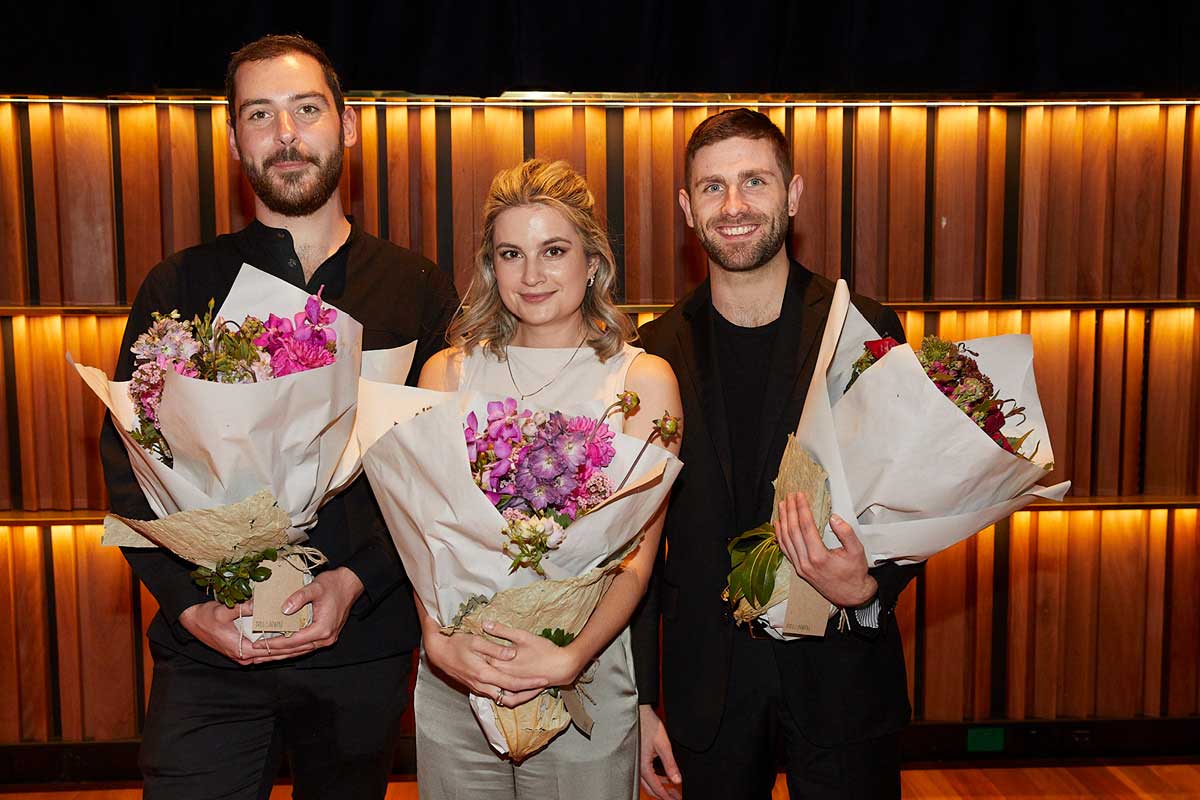Jonty Coy, Courtenay Cleary and Henry Justo holding bouquets of flowers post-perfomance in The Neilson.
