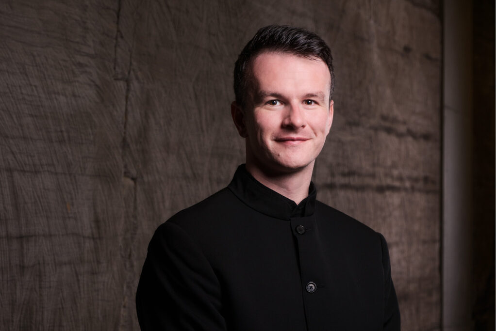 Sam Allchurch, the Artistic Director of the Sydney Chamber Choir, smiling.